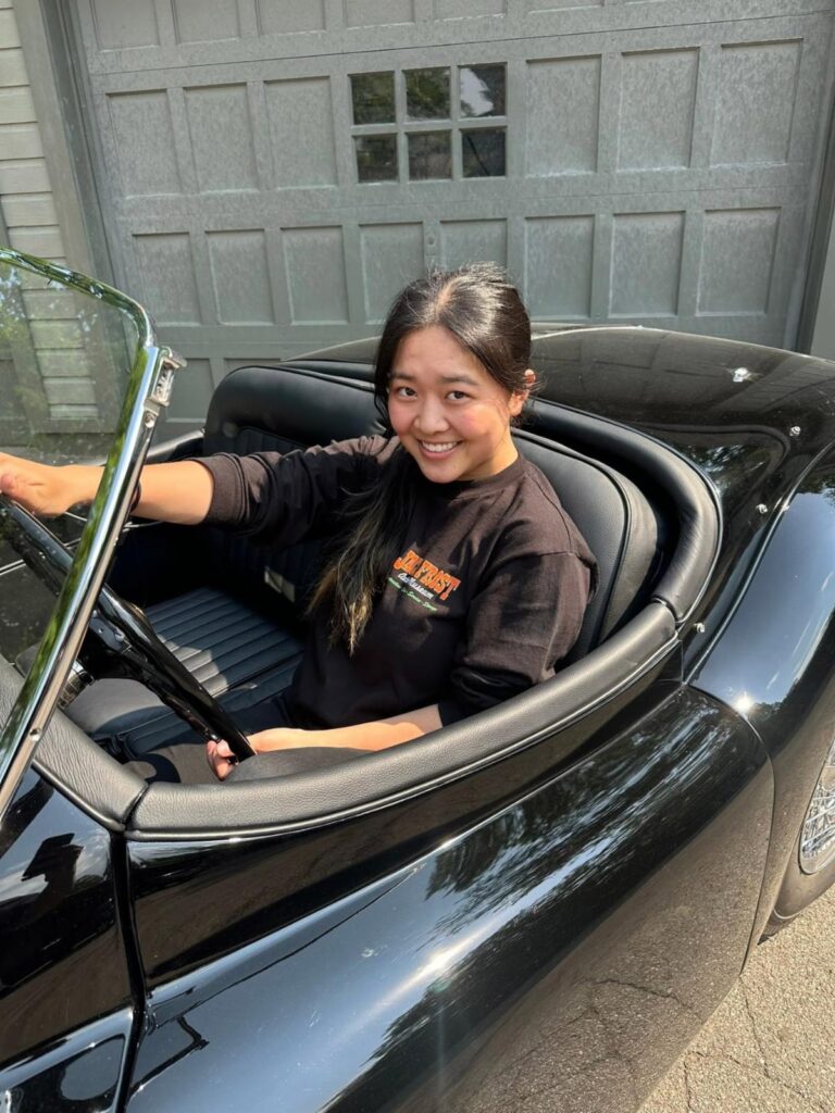 Stephanie, a Jack Frost Auto Museum intern, in a triple black 1957 Jaguar XK 140 OTS